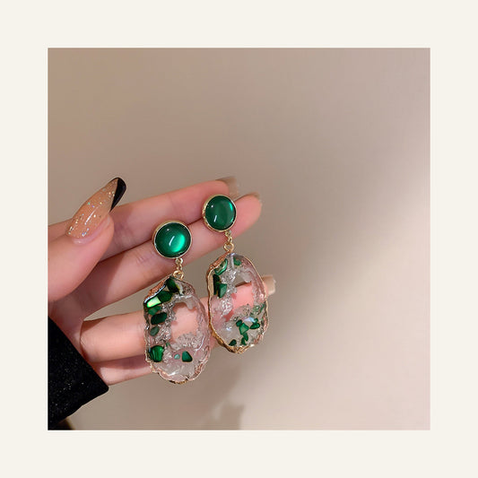 Geometric Statement Drop Earrings in green, close-up of geometric stones and floral drops