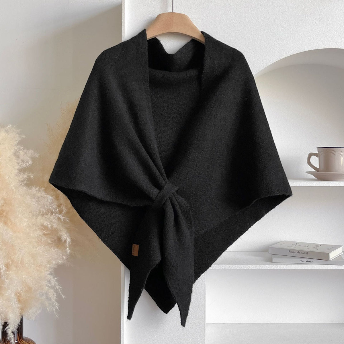 Soft Knit Triangle Shawl in black, displayed on a hanger