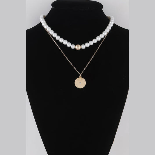 Pearl-Effect & Disc Layered Necklace in gold and cream, displayed on a necklace bust