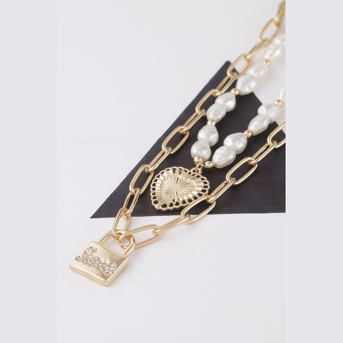 Pearl-Effect Heart & Lock Layered Necklace in gold and cream, heart and lock pendant detail