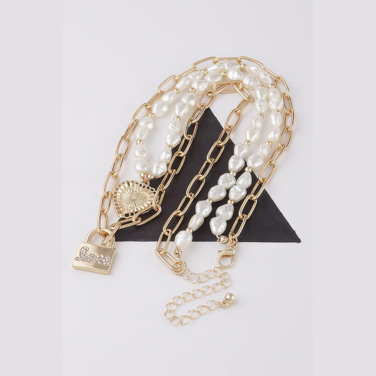 Pearl-Effect Heart & Lock Layered Necklace in gold and cream, flat lay