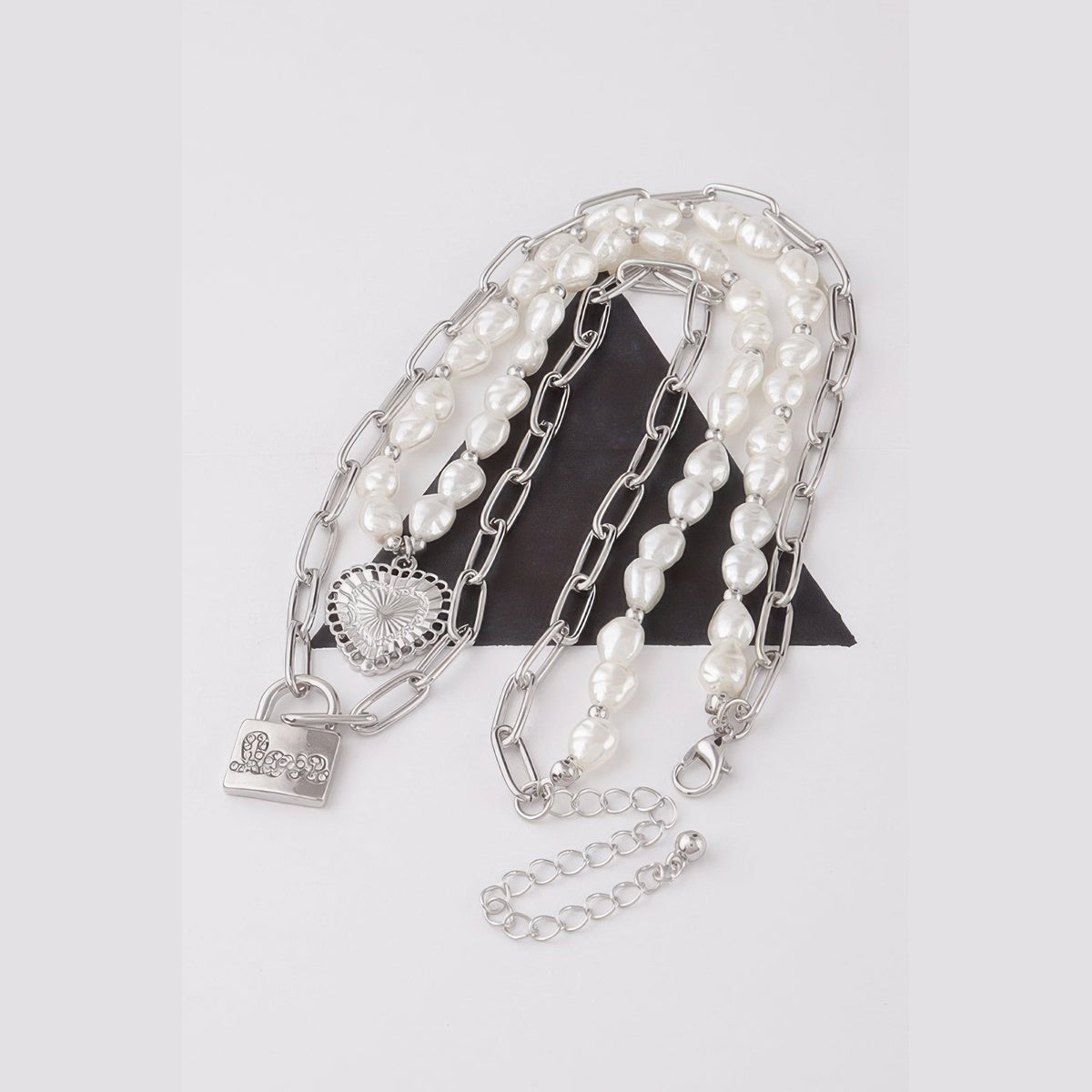 Pearl-Effect Heart & Lock Layered Necklace in silver and cream, flat lay