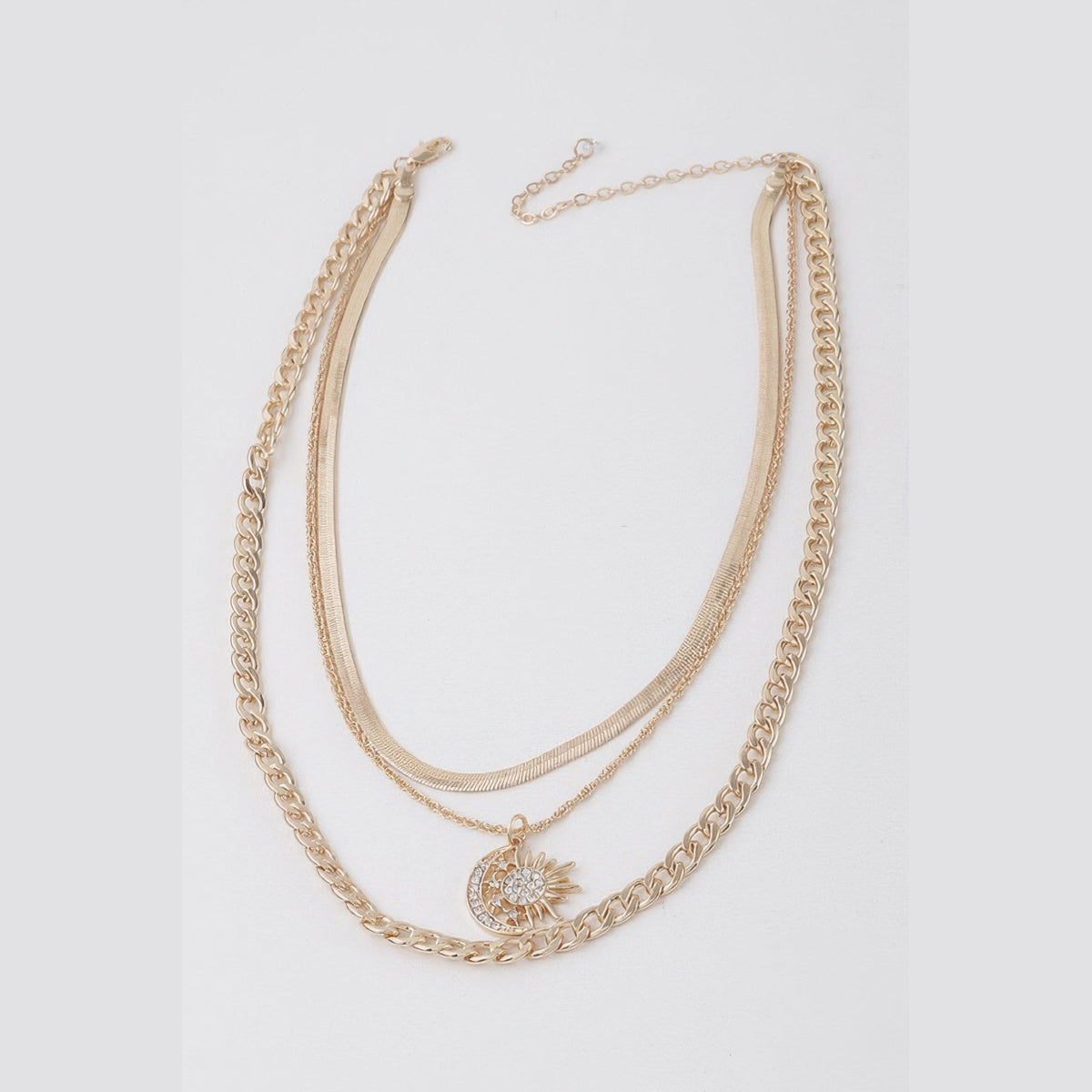 Sun & Moon Layered Necklace in gold with clear stones, flat lay