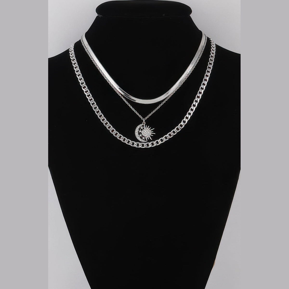 Sun & Moon Layered Necklace in silver with clear stones, displayed on a necklace bust