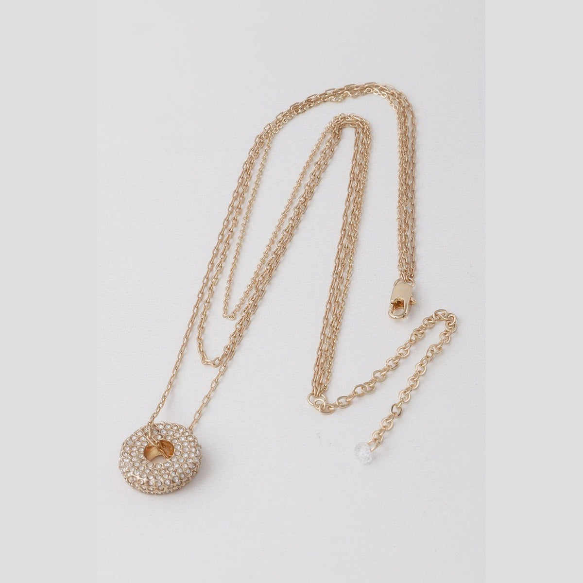 Jeweled Circle Layered Necklace in gold with clear stones, flat lay