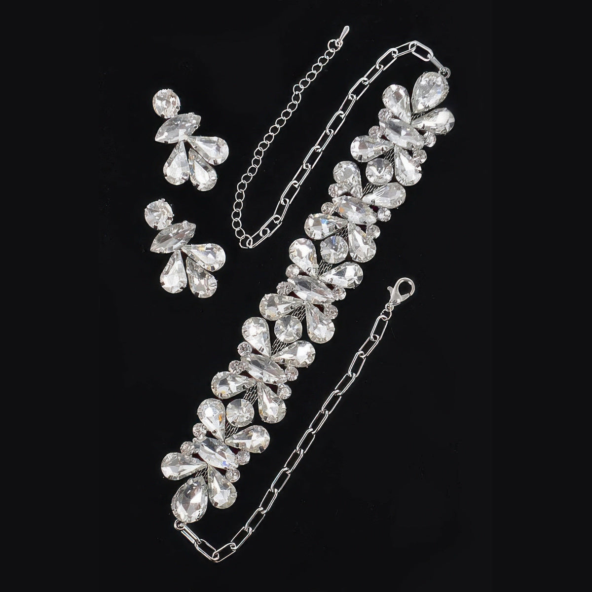 Floral Stone Necklace & Earring Set in silver with clear stones, necklace and earrings flat lay
