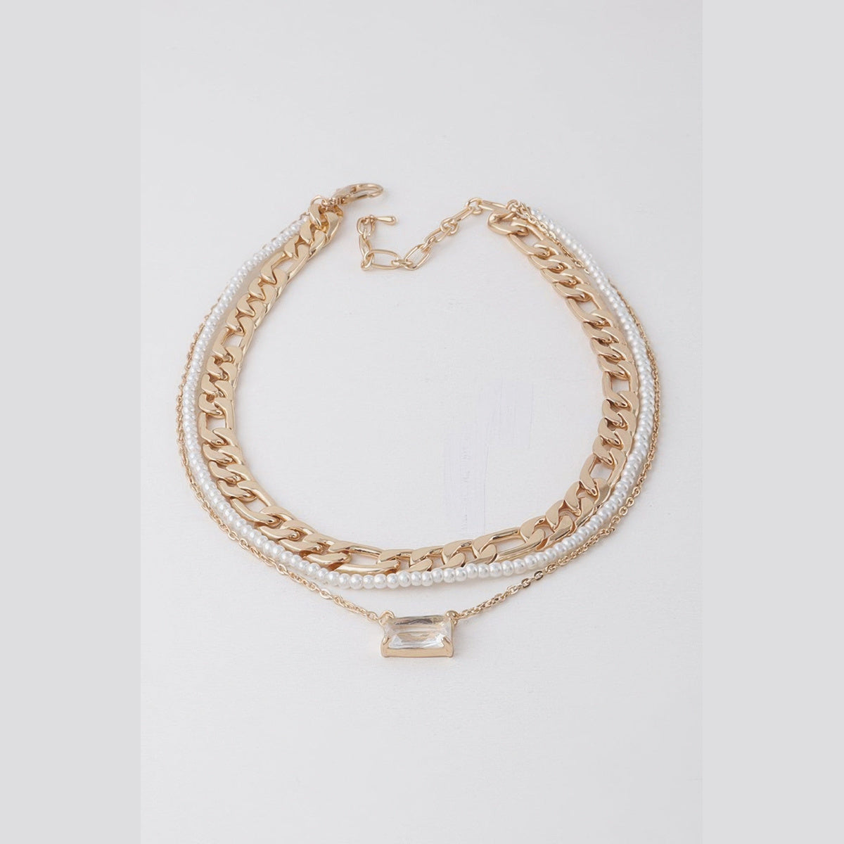 Jeweled & Pearl-Effect Layered Necklace in gold and cream, flat lay