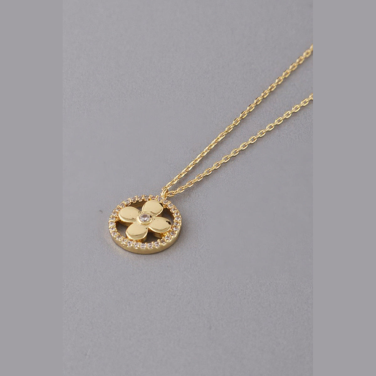 Jeweled Clover Pendant Necklace in gold with clear stones, clover pendant close-up