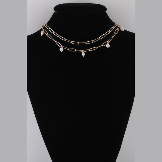 Pearl-Effect & Stone Paperclip Necklace in gold and cream, displayed on a necklace bust