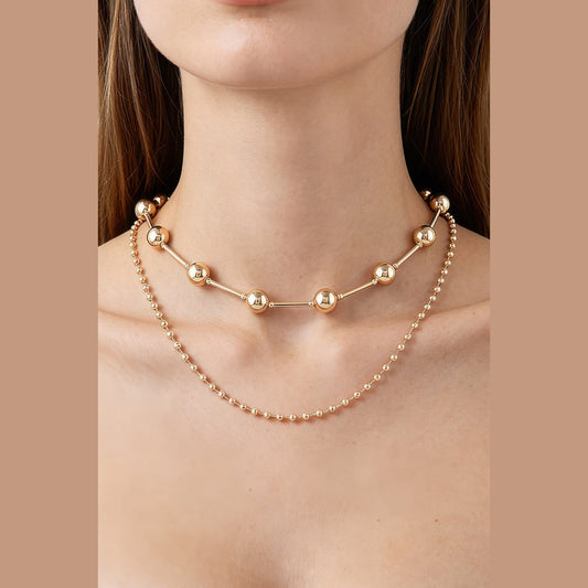Double-Layer Bead & Bar Necklace in gold, styled on a model