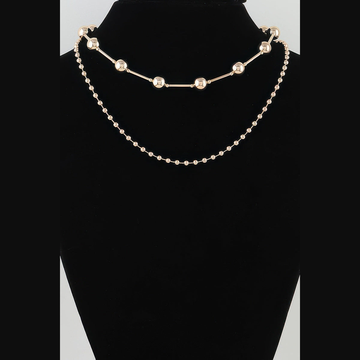 Double-Layer Bead & Bar Necklace in gold, displayed on a necklace bust