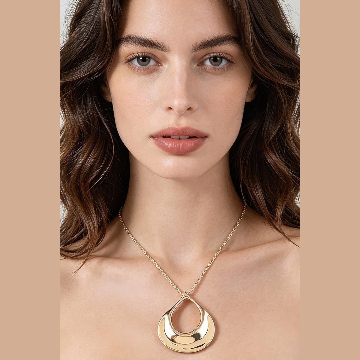 Sculptural Ripple Pendant Necklace in gold, styled on a model