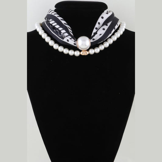 Scarf & Pearl-Effect Statement Necklace in black and white, displayed on a necklace bust