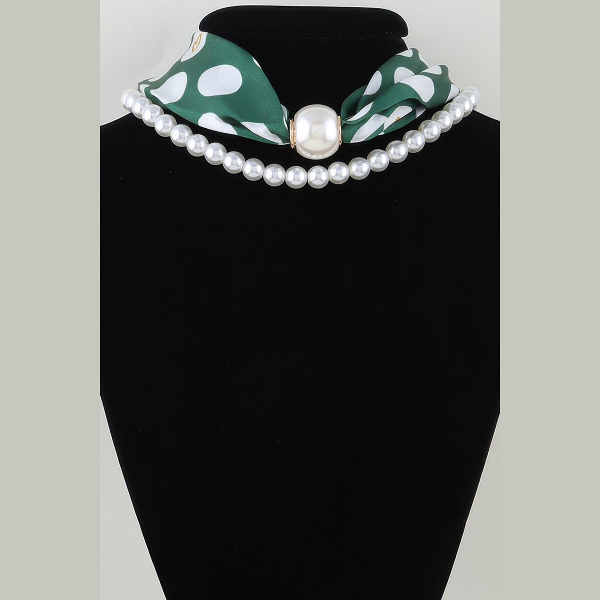Scarf & Pearl-Effect Statement Necklace in green, displayed on a necklace bust