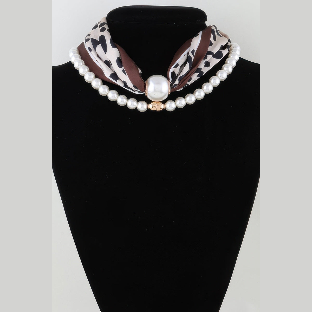 Scarf & Pearl-Effect Statement Necklace in leopard print, displayed on a necklace bust