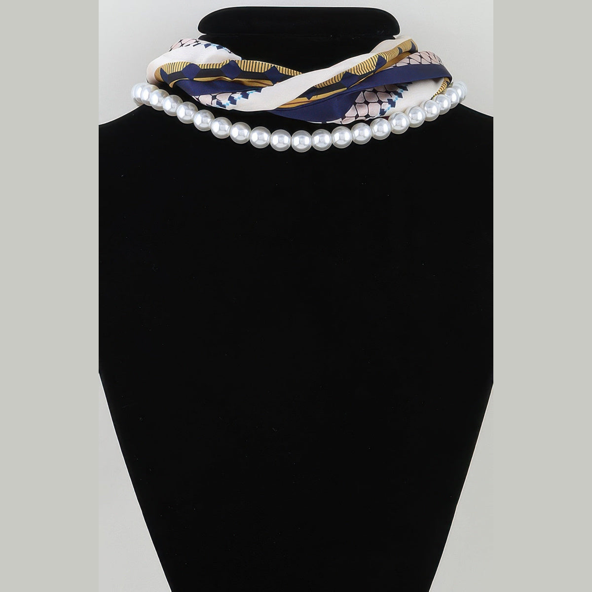 Scarf & Pearl-Effect Statement Necklace in yellow and navy, alternate view on a necklace bust