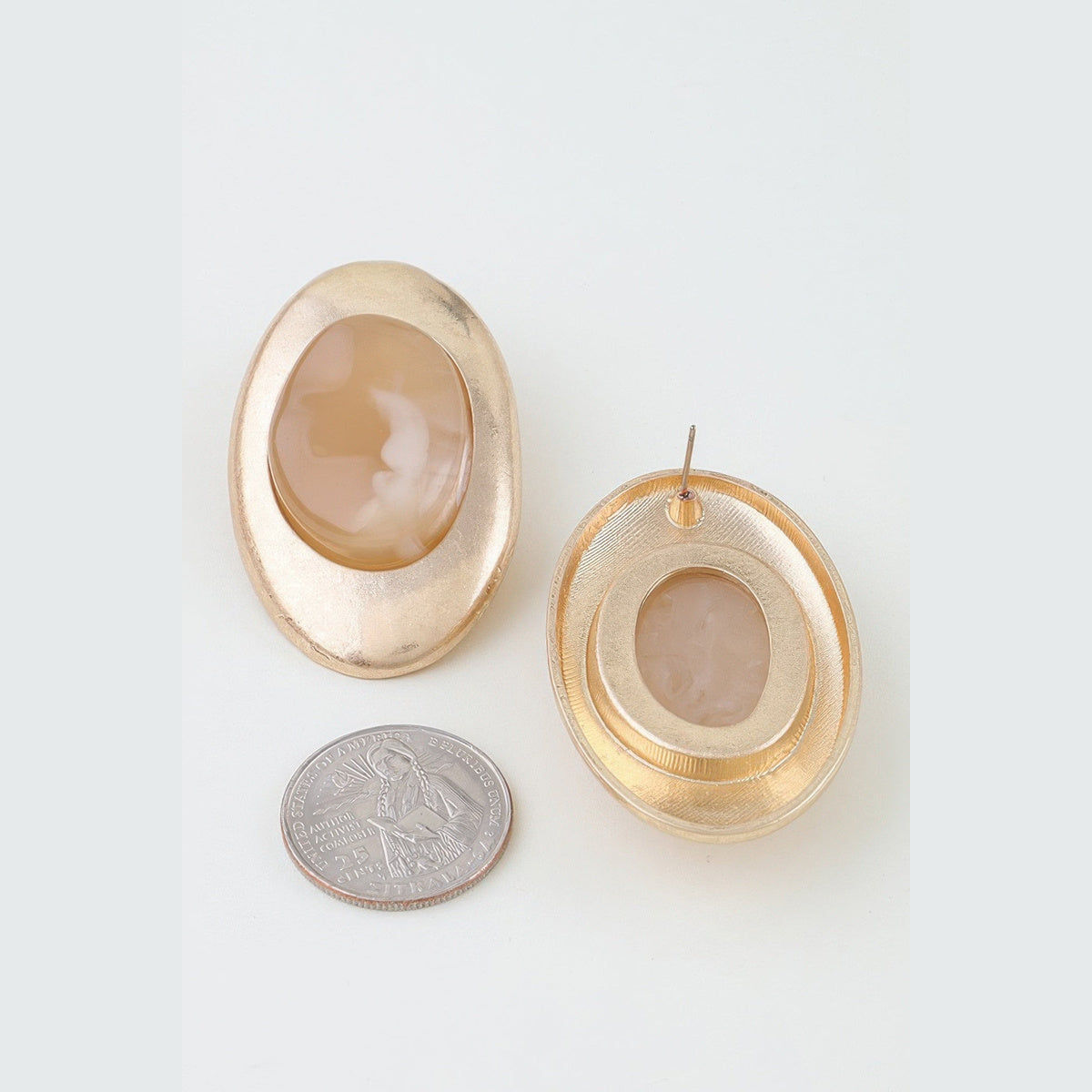 Matte Marbled Stone Statement Earrings in gold and beige, front and reverse views beside a coin for scale