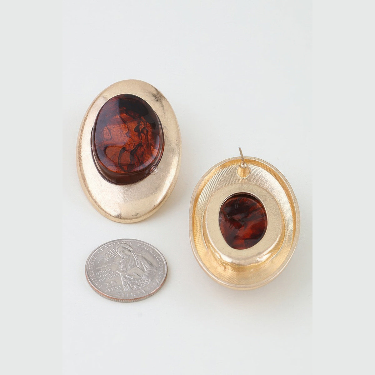 Matte Marbled Stone Statement Earrings in gold and brown, front and reverse views beside a coin for scale