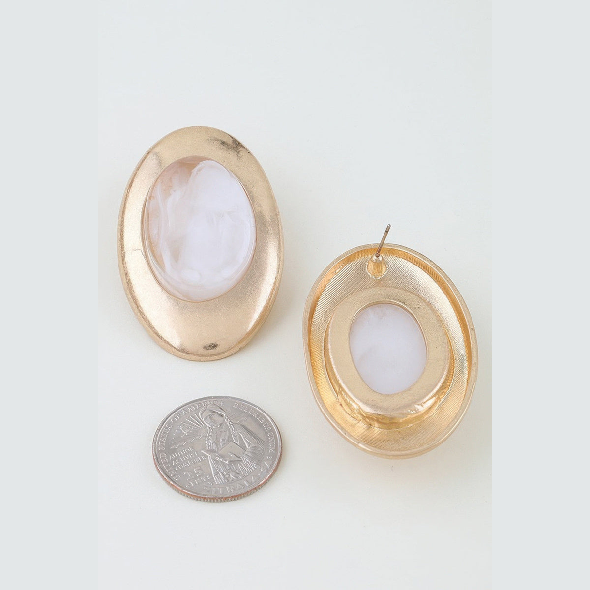 Matte Marbled Stone Statement Earrings in gold and white, front and reverse views beside a coin for scale