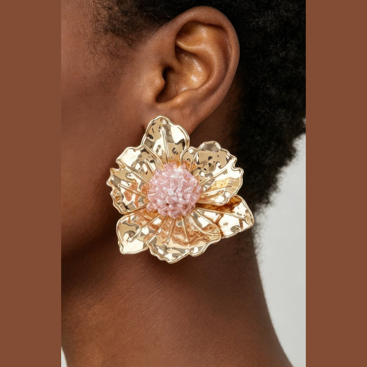 Pink Beaded Flower Statement Earrings in gold and pink, close-up worn on the ear