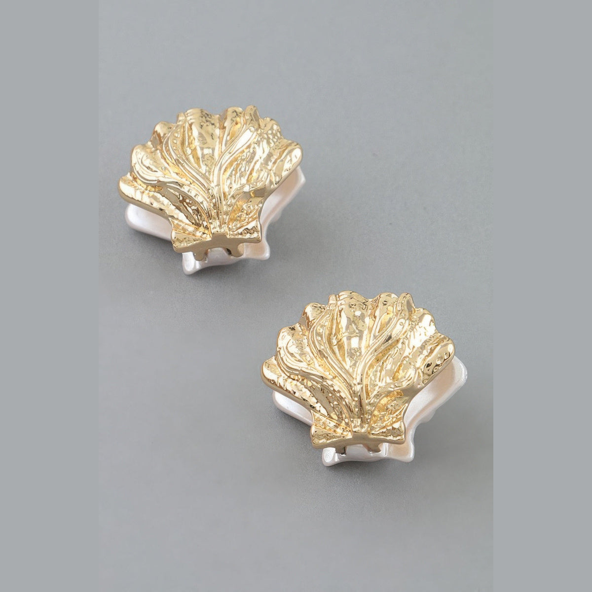 Two-Tone Clamshell Earrings in gold and pearl white, pair shown from the front