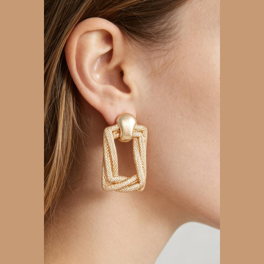 Braided Door-Knocker Earrings in gold, close-up worn on the ear