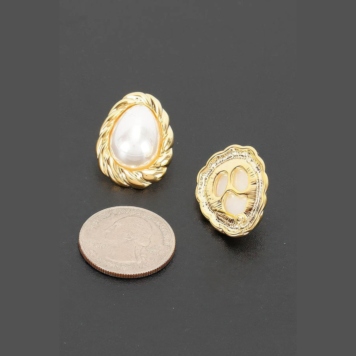 Twisted Frame Pearl-Effect Stud Earrings in gold and pearl white, earring backs beside a coin for scale