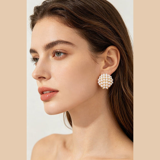 Pearl-Effect Cluster Clip-On Earrings in gold and cream, styled on a model