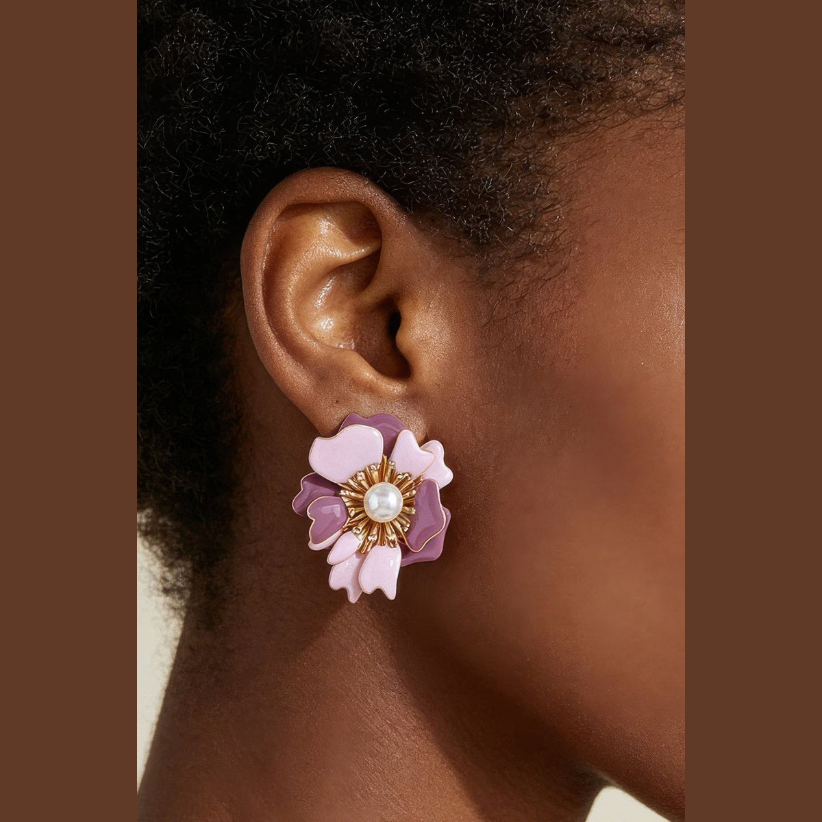 Marbled Blossom Statement Earrings in gold and pink, styled on a model