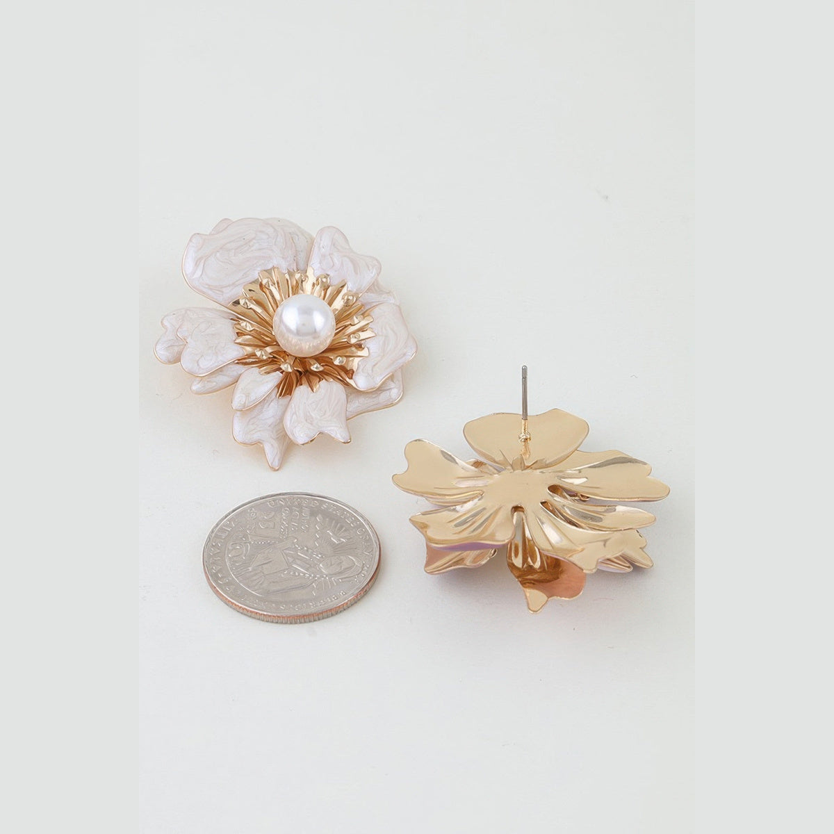 Marbled Blossom Statement Earrings in gold and ivory, front and reverse views beside a coin for scale