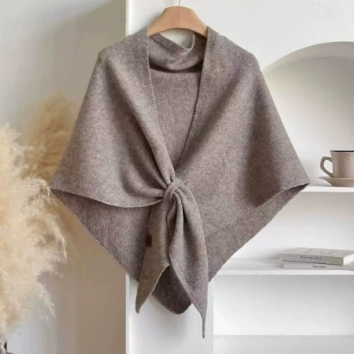 Soft Knit Triangle Shawl in camel, displayed on a hanger