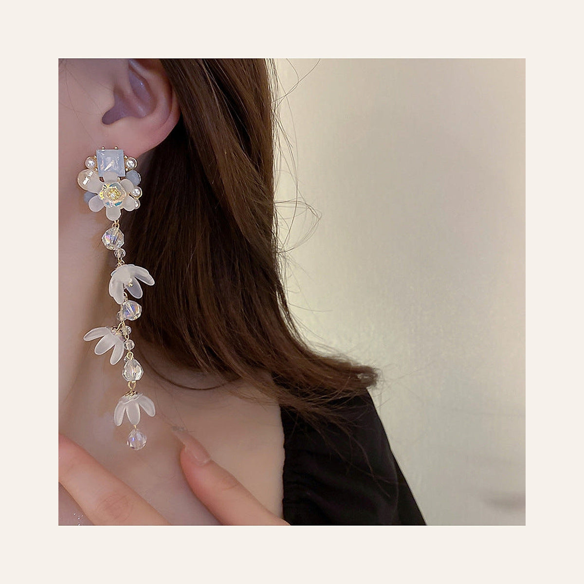 Blue Pearl & Crystal Floral Tassel Earrings in blue and pearl white, worn on the ear