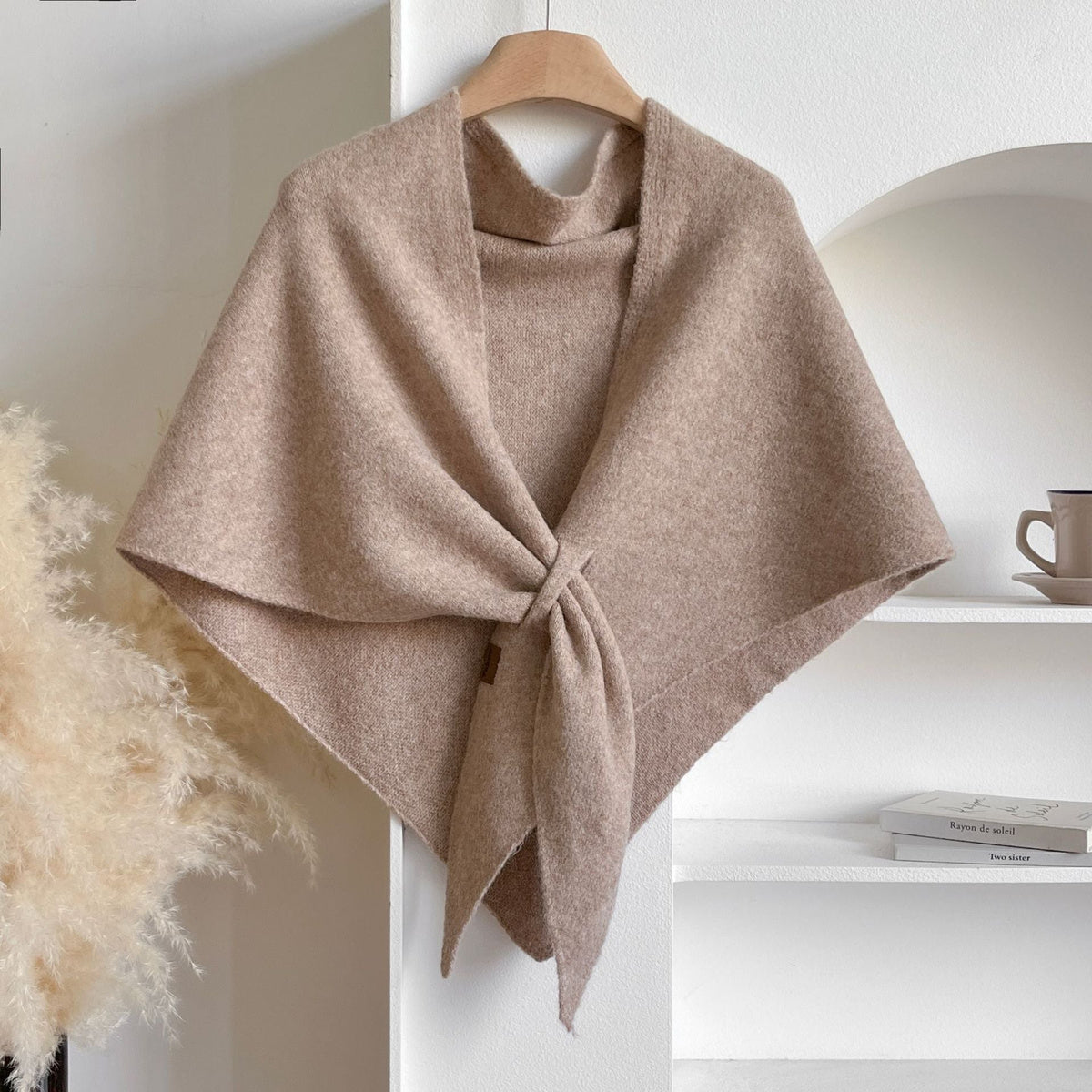 Soft Knit Triangle Shawl in beige, displayed on a hanger