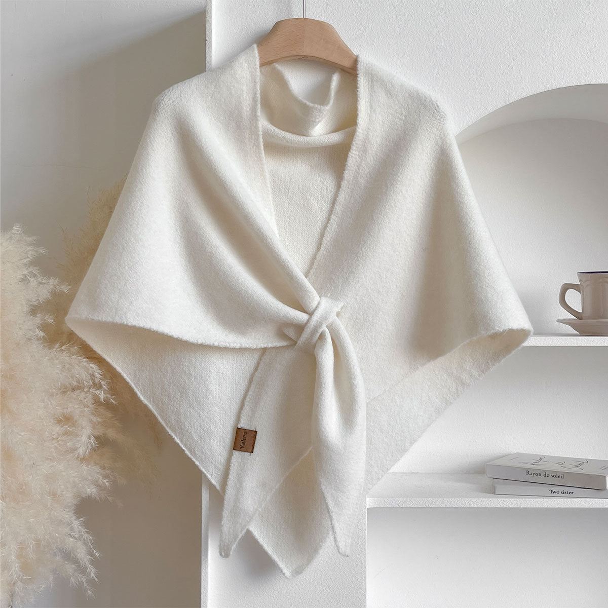 Soft Knit Triangle Shawl in white, displayed on a hanger