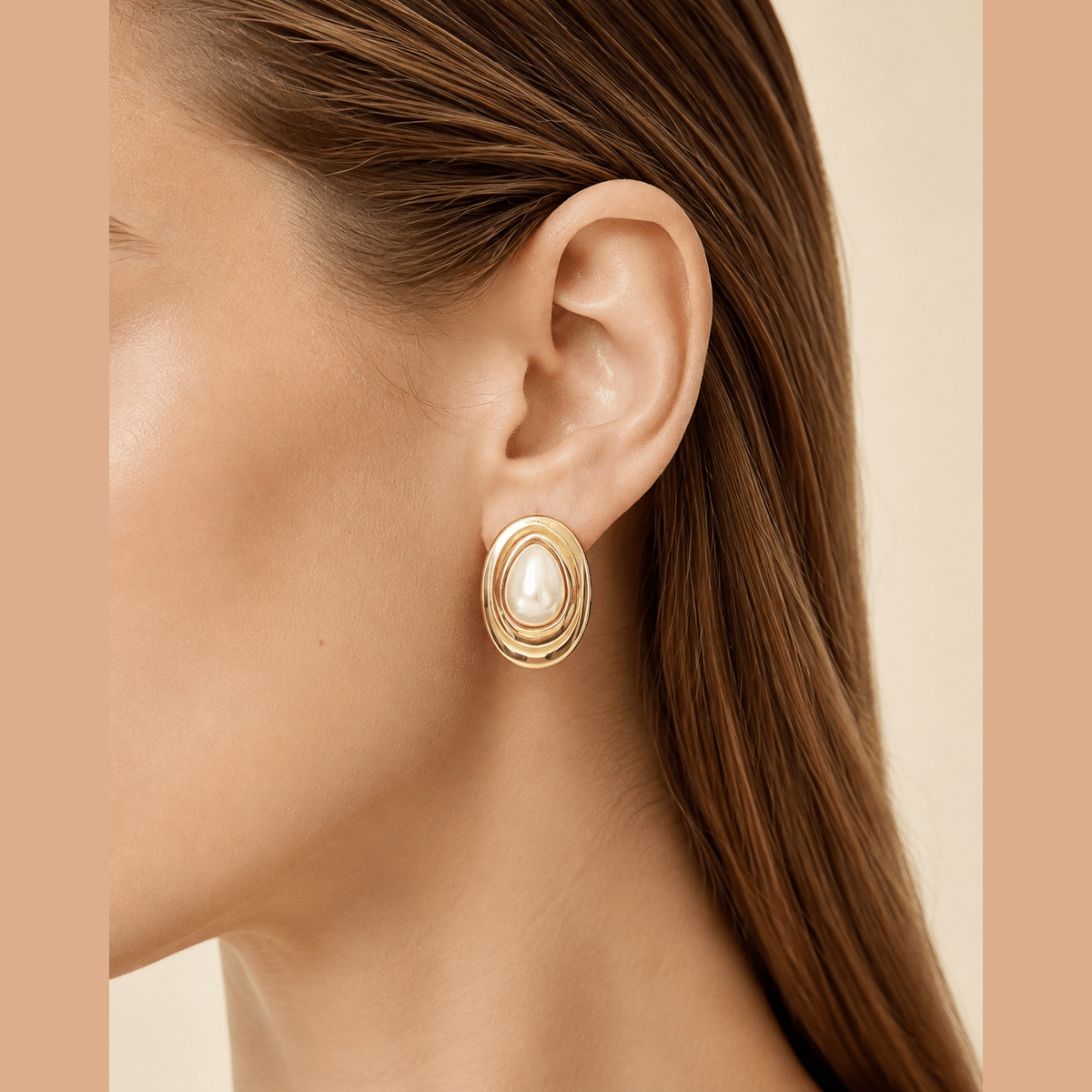 Layered Oval Pearl-Effect Stud Earrings in gold and pearl white, worn on the ear