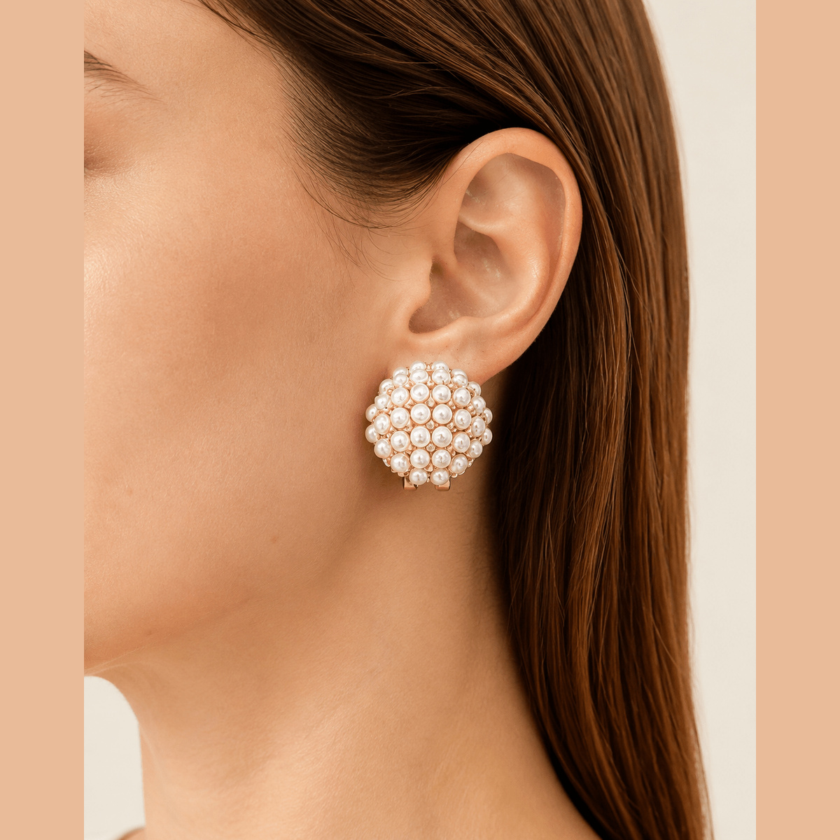 Pearl-Effect Cluster Clip-On Earrings in gold and cream, worn on the ear
