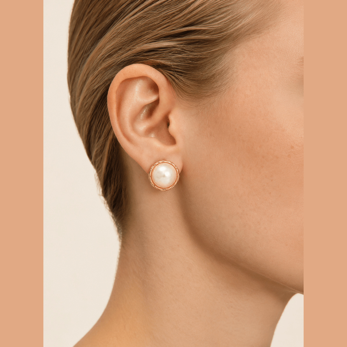 Braided Pearl-Effect Stud Earrings in gold and pearl white, worn on the ear