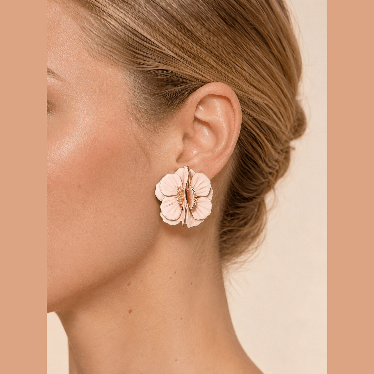 Layered Blossom Statement Earrings in gold and pink, worn on the ear