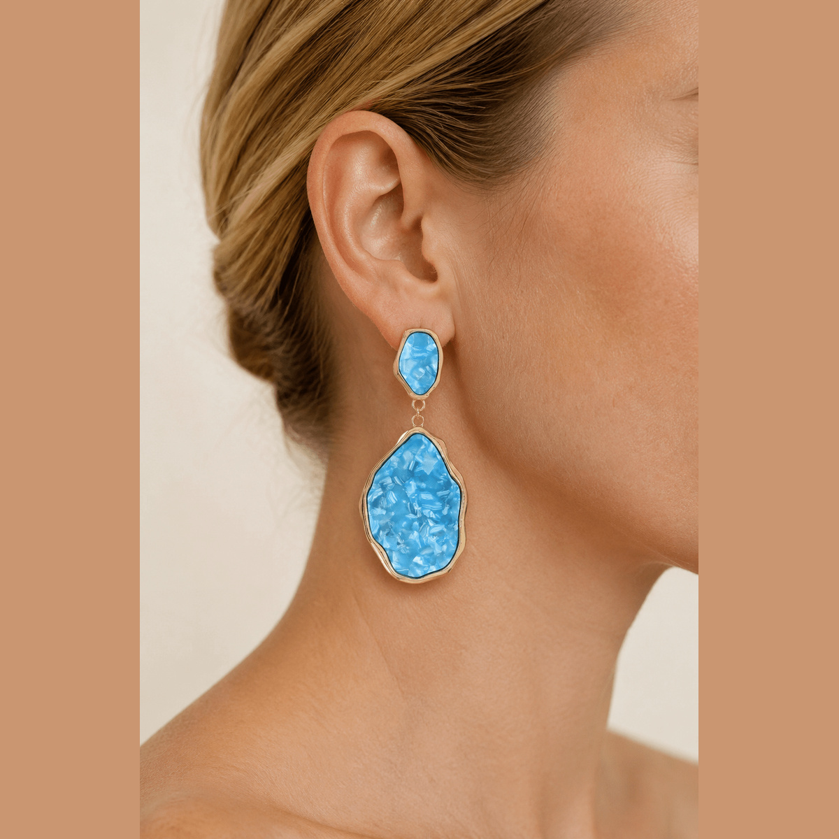 Abstract Stone-Effect Statement Drop Earrings in gold and aqua, worn on the ear