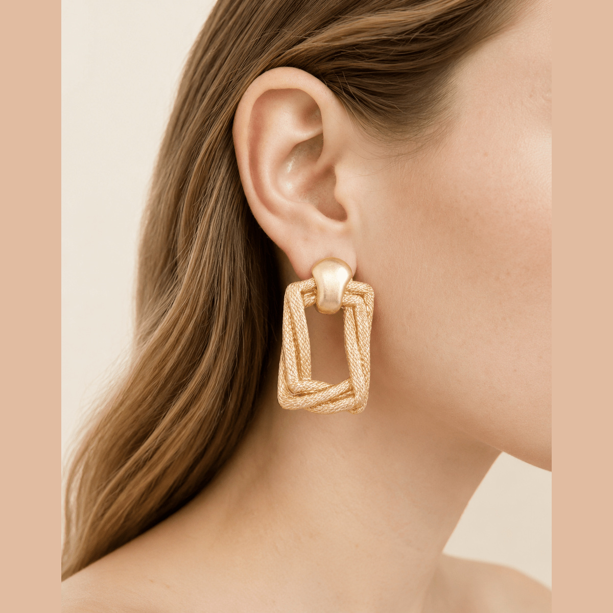 Braided Door-Knocker Earrings in gold, worn on the ear