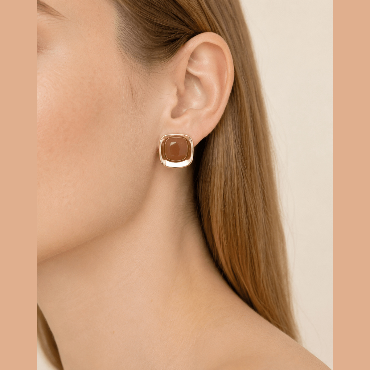 Polished Marbled Stone Stud Earrings in gold and brown, worn on the ear