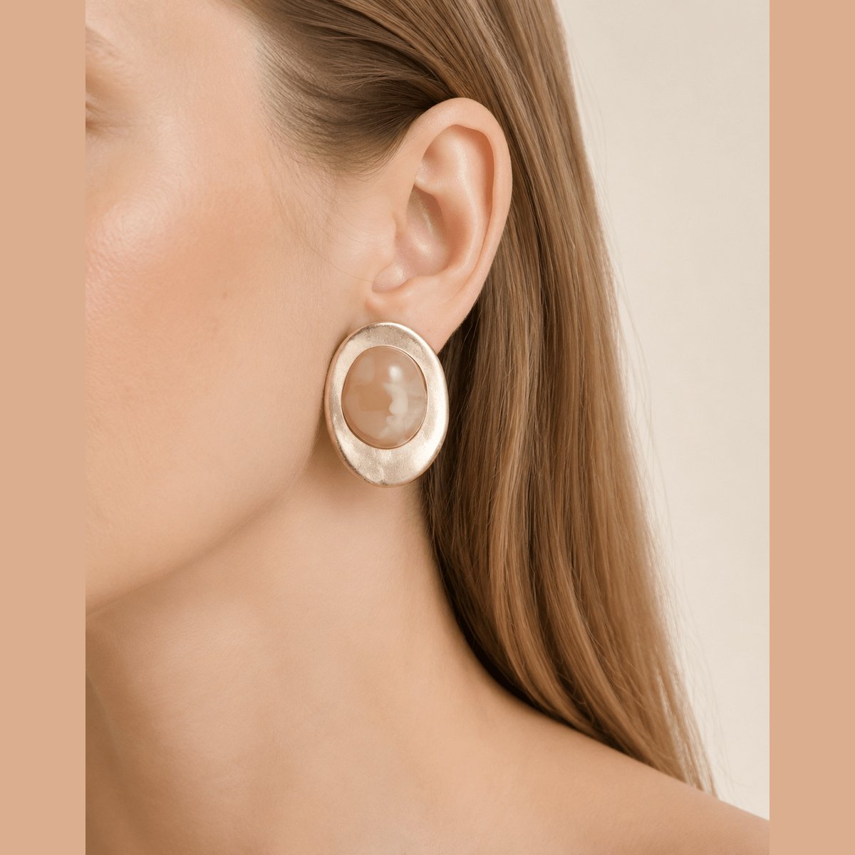 Matte Marbled Stone Statement Earrings in gold and beige, worn on the ear