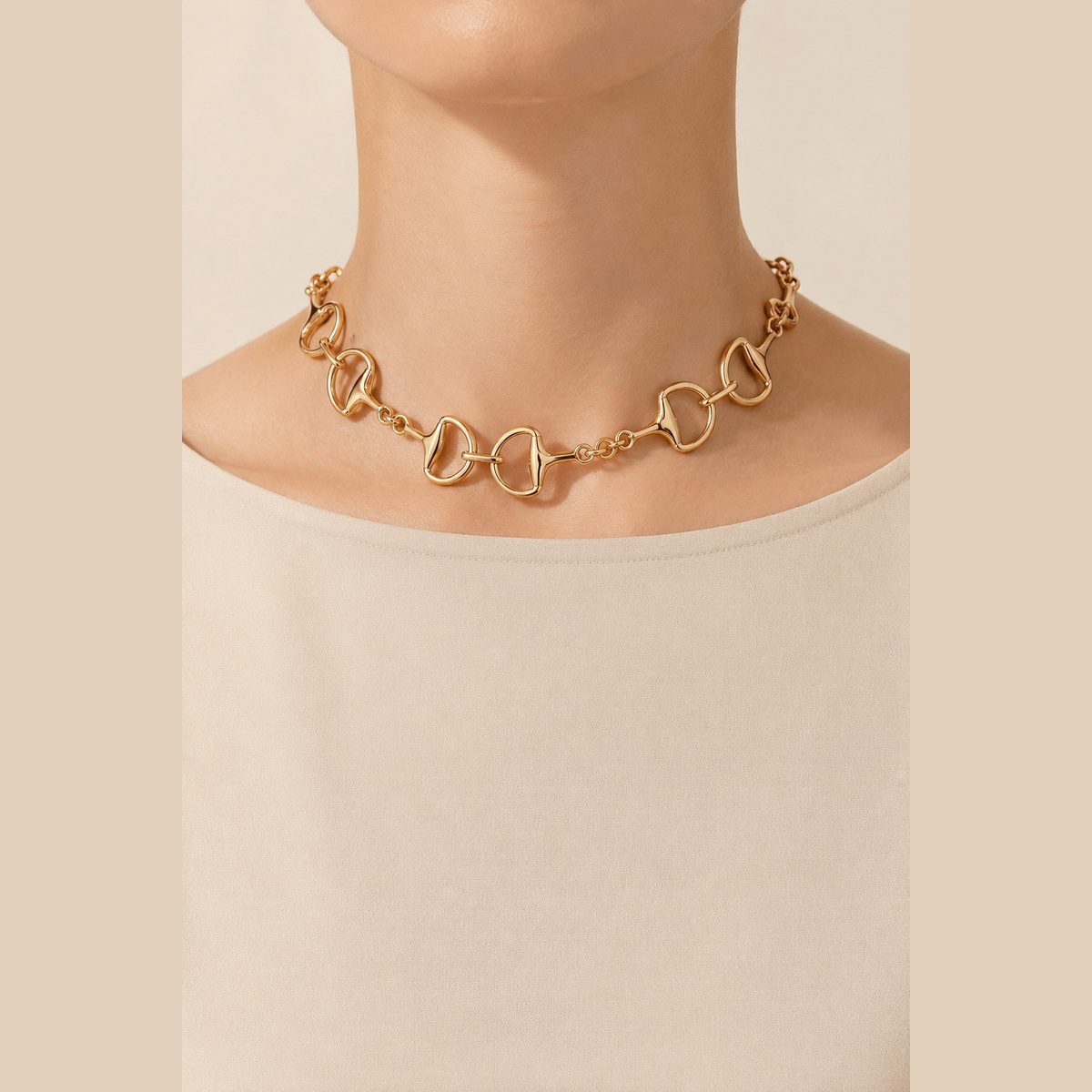 Polished Toggle-Link Choker in gold, worn at the neckline