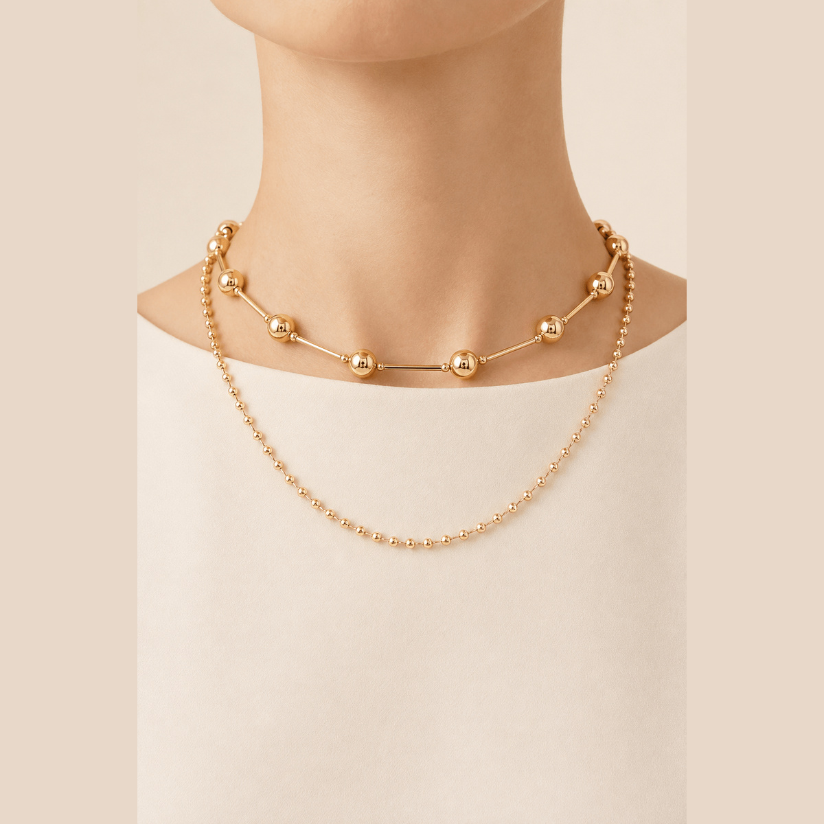 Double-Layer Bead & Bar Necklace in gold, worn around the neck