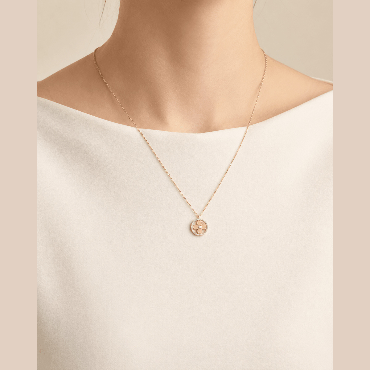 Jeweled Clover Pendant Necklace in gold with clear stones, worn around the neck