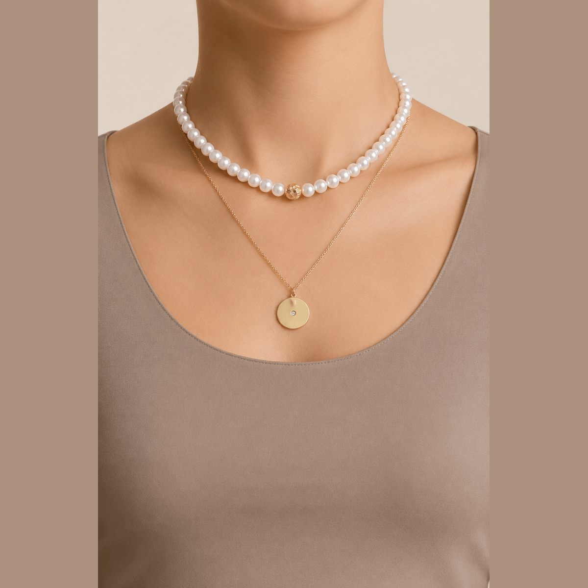Pearl-Effect & Disc Layered Necklace in gold and cream, worn around the neck