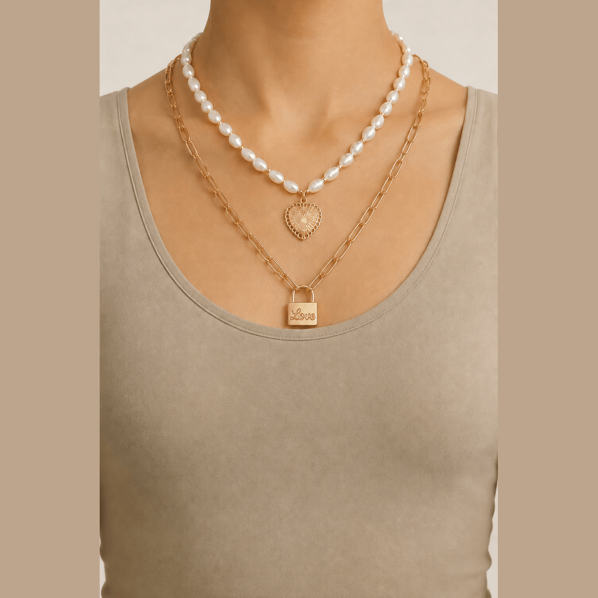 Pearl-Effect Heart & Lock Layered Necklace in gold and cream, worn around the neck