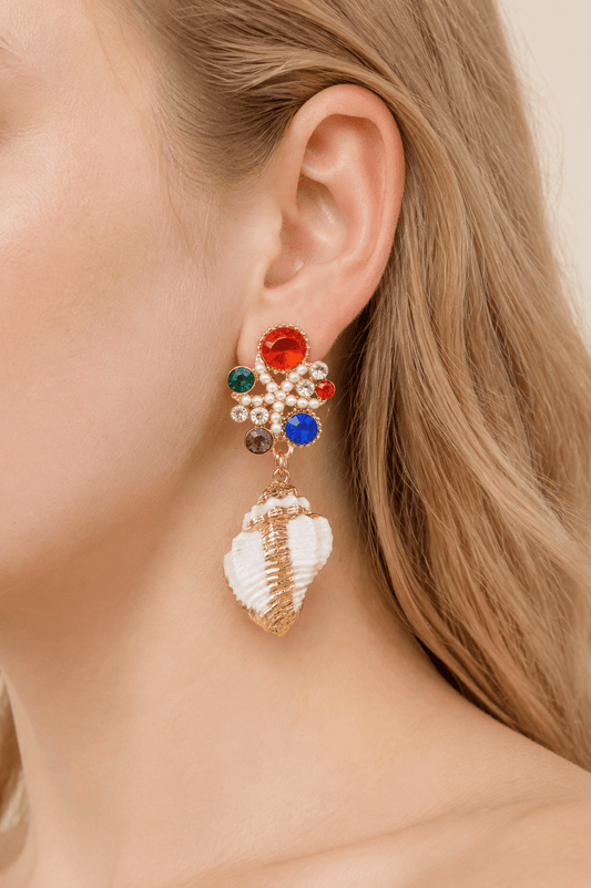 Close-up of a model wearing multicolor jeweled shell statement drop earrings