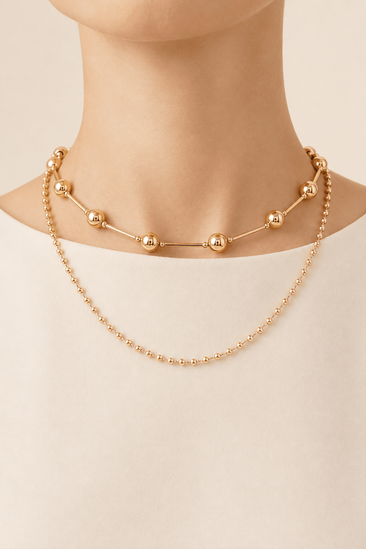Double-layer bead and bar necklace worn on a fair-light skin model