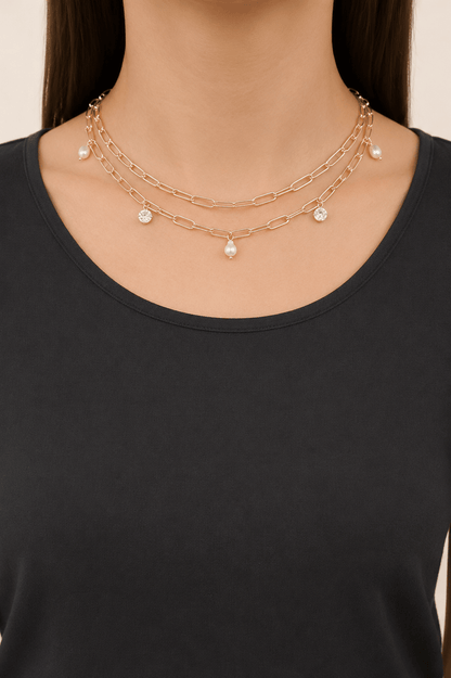 Pearl-effect and stone paperclip necklace worn on a fair-light skin model